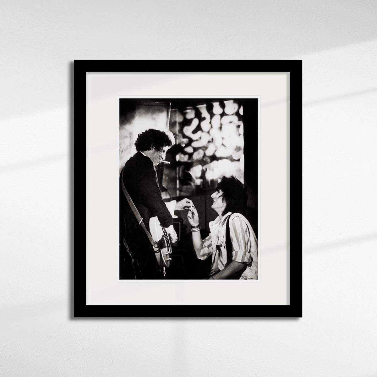 Keith Richards & Ronnie Wood, Paris, 1983 sharing a cigarette - by Brian Aris.