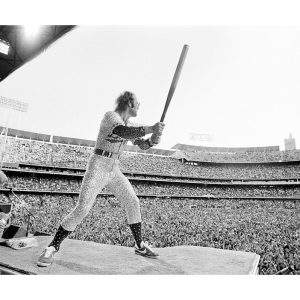 Elton John peforming with a baseball bat, 1975 — Limited Edition Print by Terry O'Neill