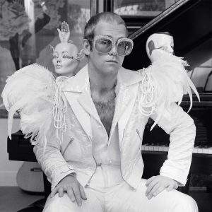 Elton John wearing a white feather suit, circa 1973 — Limited Edition Print by Terry O'Neill