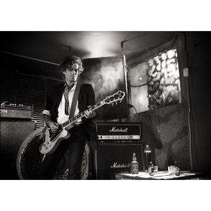 Keith Richards with guitar and JD by Brian Aris