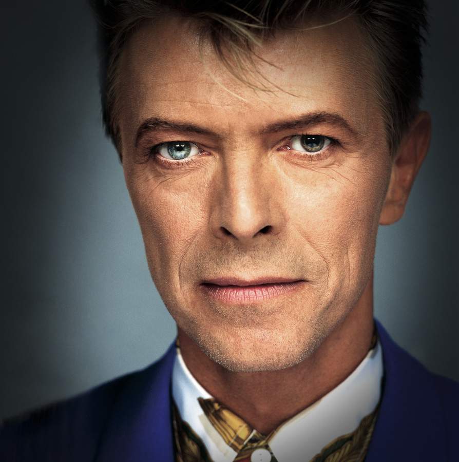 Limited edition print of David Bowie in blue suit and Versace shirt by Brian Aris.
